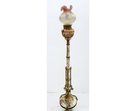 A late 19th century tall ceramic oil lamp stand, having stylised twisted and curved brass supports, details and base rim, on 
