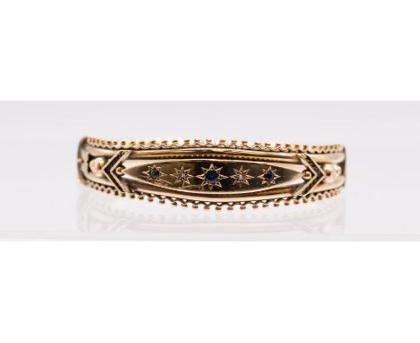 A Victorian sapphire and diamond 9ct gold hinged bangle, comprising a raised central section set with a row of alternate star