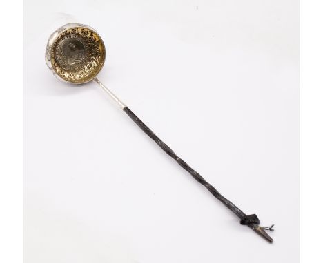 A Victorian silver toddy ladle, the centre inset with Spanish Netherlands thaler, the body engraved with ribbon tied swags, e