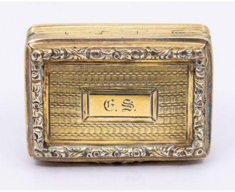 A George IV silver gilt vinaigrette, book shaped ornate scrolling raised border, engine turned decoration with central cartou
