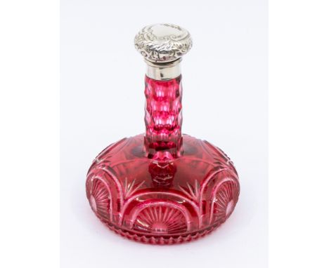 A late Victorian onion shaped ruby glass scent bottle, incised paterae to lower section, with plain silver collar and hinged 