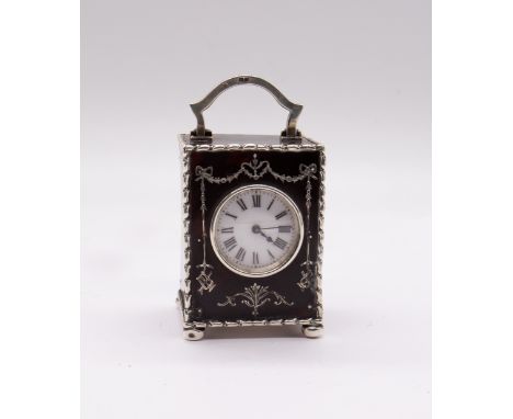 An Edwardian silver mounted tortoiseshell mounted miniature carriage clock, the case with bell flower silver border, the fron