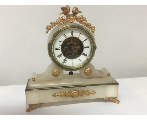 A late 19th century Alabaster mantel clock with a visible escapement height 30cm