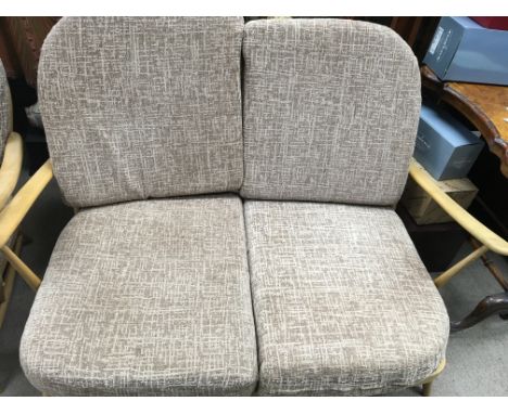 A Ercol two seater sofa and two matching open arm chairs.