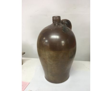 An interesting 19th century stoneware wine flagon with salt glaze two tone finish and impressed R Grimbly  Wine Merchants Ban