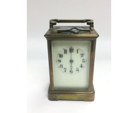 A brass cased carriage clock with key. Shipping category D. NO RESERVE