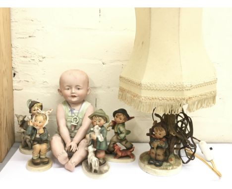 A bisque doll &amp; Goebel West German figurines including a lamp, postage cat D
