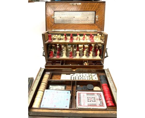 A Royal Cabinet of Games, oak compendium cabinet. To include a complete set of Bone Chess pieces, markers, Bezique, Part Domi