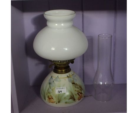 A good pottery and opaque glass oil lamp with clear reservoir  