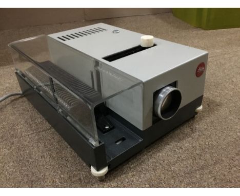 LEITZ SLIDE PROJECTOR, TRIPOD AND KODAK SLIDE, along with a lamp light
