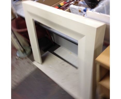 A modern fire surround with composite hearth.