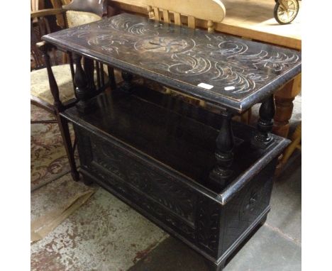 A carved oak monk's bench. L92cm D45cm H74cm.