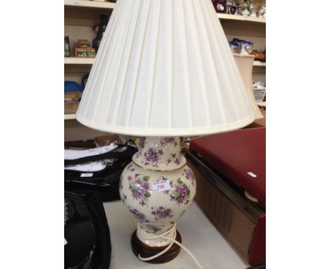 A floral table lamp, height 61cm. RTO