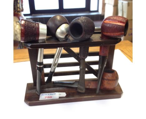 5 vintage pipes on rack. C