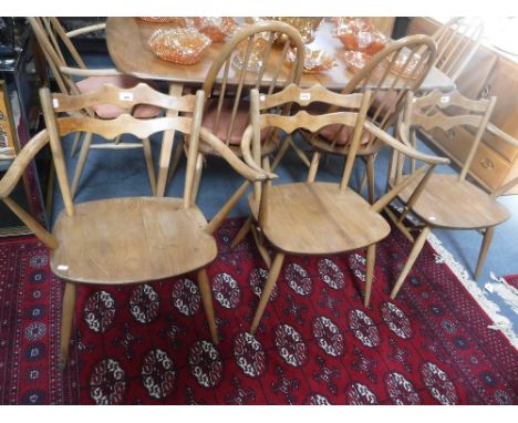 ERCOL: THREE PALE ELM AND BEECH ELBOW CHAIRS with cow-horn arms and shaped back rails