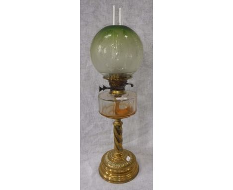 A VICTORIAN OIL LAMP, with brass base, cut glass reservoir and original green frosted shade 