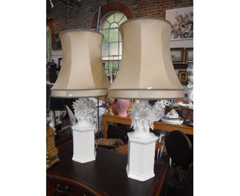 A PAIR OF LARGE WHITE GLAZED CERAMIC TABLE LAMPS of hexagonal form with floral and leaf decorated tops, each with gold lined 