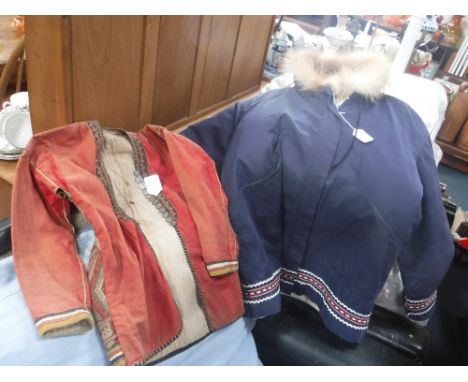 AN EARLY 20TH CENTURY LADIES'S  RED JACKET from Sarawak with embroidered detail, with 5 and  10 cent Victorian and later 'Str