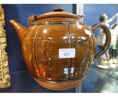 RICHARD BATTERHAM: A LARGE STONEWARE TEAPOT, brown glaze with incised decoration 10" high (including lid) 