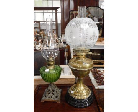 AN EDWARDIAN BRASS OIL LAMP with original frosted shade and a similar oil lamp