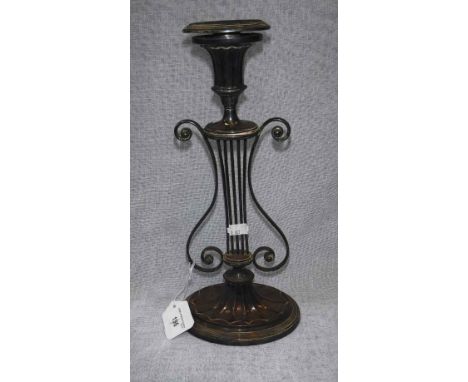 A SILVER PLATED CANDLESTICK  with 'lyre' support 