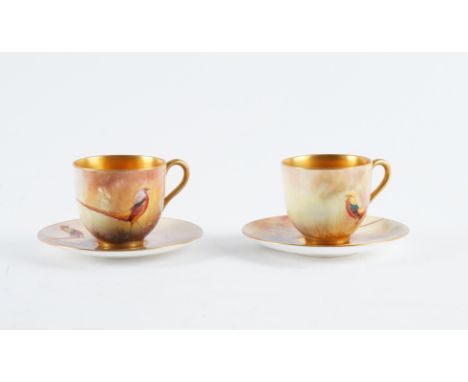 A PAIR OF ROYAL WORCESTER COFFEE CUPS AND SAUCERS (4)Circa 1920 Each piece painted with a golden pheasant, the saucers signed