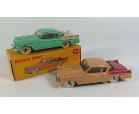 Two Dinky 169 Studebaker Golden Hawk Cars _ one in light green and cream with cream hubs, boxed the other tan with red side p
