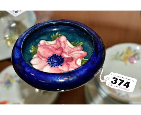 A MOORCROFT POTTERY LIPPED TRINKET DISH, 'Anemone' pattern on blue ground, diameter overall 11cm
