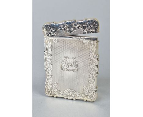 A MID VICTORIAN SILVER CARD CASE OF WAVY RECTANGULAR OUTLINE, foliate engraved and engine turned cartouche with monogram, hin