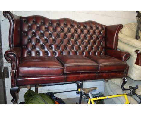 A RED LEATHER WINGED THREE SEATER SOFA, width 180cmCondition Report  Good condition 