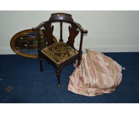 AN EDWARDIAN MAHOGANY CORNER CHAIR together with an oak oval wall mirror and a pair of pink stripped curtains (3)Condition Re