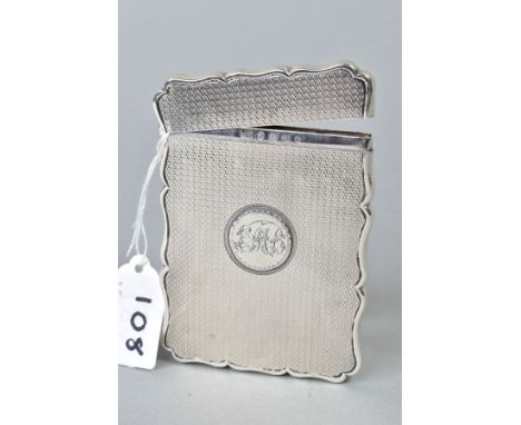 A MID VICTORIAN SILVER CARD CASE OF WAVY RECTANGULAR FORM, hinged top, engine turned decoration, circular cartouche engraved 