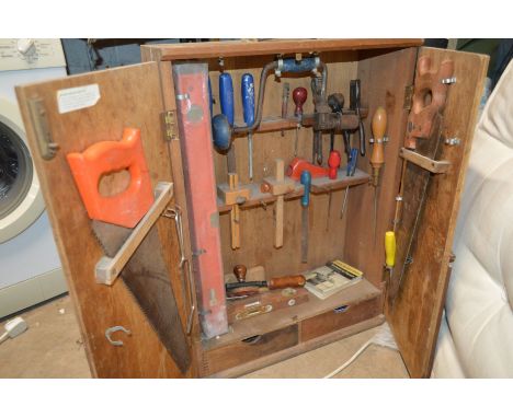 A VINTAGE WOODEN DOUBLE DOOR TOOLBOX containing hand tools including Spear and Jackson, Marples etc