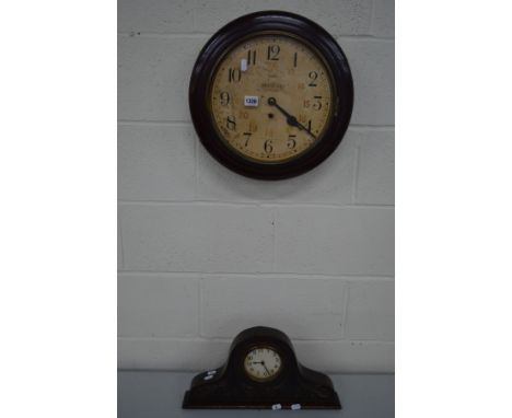 AN EARLY TO MID 20TH CENTURY CIRCULAR OAK WALL CLOCK, together with a carved oak mantel clock (2)