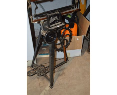 A HOBBIES MANUAL SCROLL SAW on cast metal stand