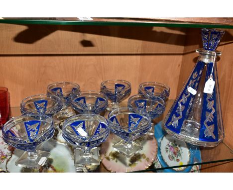 AN ART DECO SHAPED GLASS DECANTER AND MATCHING NINE FOOTED DISHES (10)Condition report  Clouding on several pieces, some scra