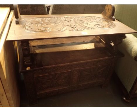 Carved oak monks' bench with lion arms and lifting lid storage, 92 x 51 cm