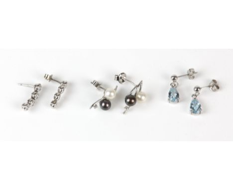 Three pairs of earrings, including a pair of diamond journey earrings, a pair of blue topaz drop earrings, both in white meta