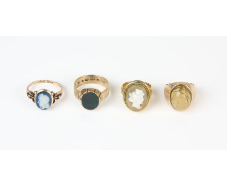 Four rings, including a cameo ring, comprised of a base metal cameo mounted on a 22 ct wedding band, ring size G½, a bloodsto