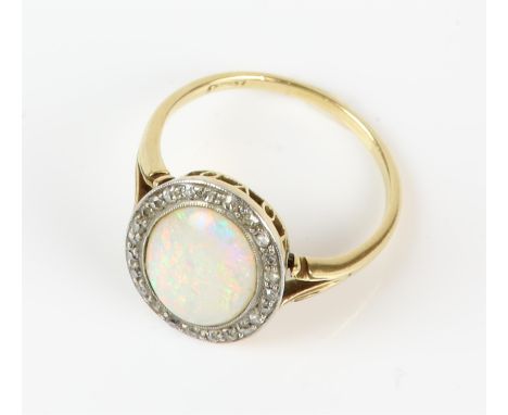 Opal and diamond ring, central oval cabochon cut opal weighing an estimated 2.41 carats, with a halo of single cut diamonds, 