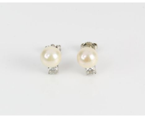 Pearl and diamond stud earrings, with a 8.5mm cream pearl with pink overtones, and a 0.25 carat round brilliant diamond set b