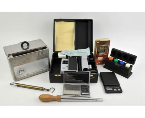 Jewellery testing equipment including a Rayner Dialdex refractometer, scales, a ring sizing stick, a spring scale, some acid 