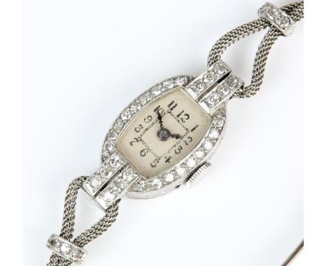 Art Deco diamond cocktail watch, patina dial with Arabic hour markers, with diamonds set around the face, case testing as pla