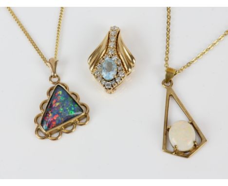 Three pendants including a blue topaz and diamond pendant in tested 14 ct, an opal pendant and opal triplet, both in stamped 