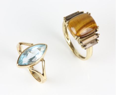 Two 9 ct gem set rings, including a marquise cut blue topaz ring, ring size K, together with a tigers eye and smoky quartz ri