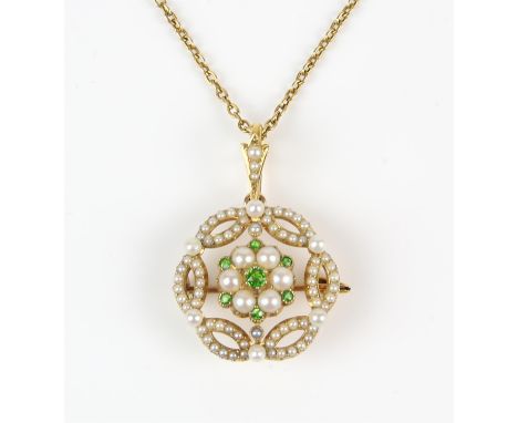 A pearl and demantoid garnet openwork pendant brooch, with central floral motif set with round cut demantoid garnets and seed