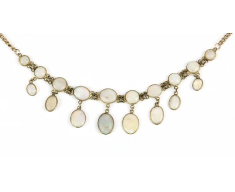 An opal necklace, with integrated slices of opal set with opal drops to the centre of the gold plate curb chain, 54 cm in len