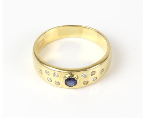 Sapphire and diamond ring, central round cut sapphire, with single cut diamond set to either side, in 18 ct gold stamped 750,