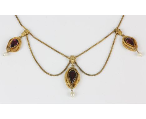 Victorian garnet and pearl necklace, three pear cut garnets, each set in a coiled snake border, with a pearl drop suspended f