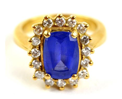 Tanzanite and diamond cluster ring, central claw set cushion cut tanzanite weighing an estimated 3.00 carats, set in a border